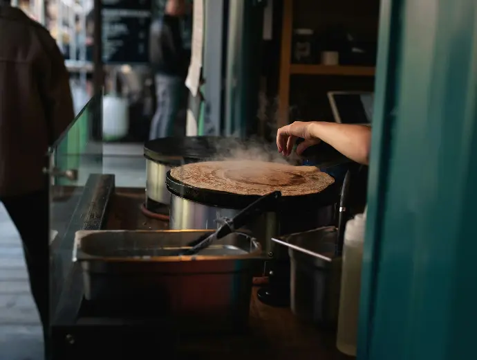 person cooking at steamer